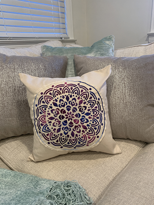 medallion stenciled pillow sitting on couch