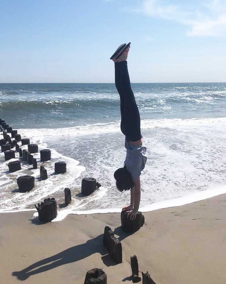 Alex doing a handstand on beach