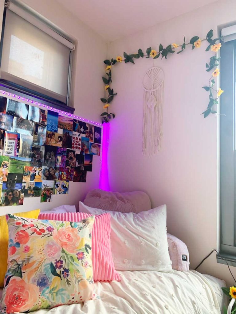 emmas dorm room with colorful pillows and photos