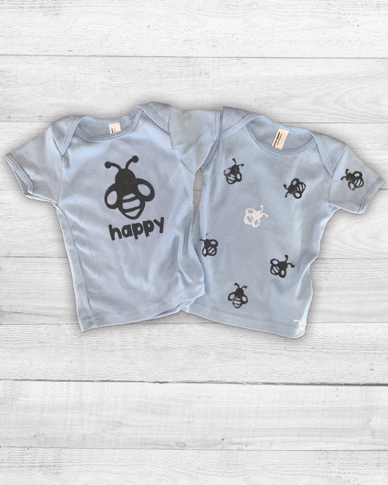 Printed kids t-shirts 1 with a groahic of a bee then words happy another with an allover bee print