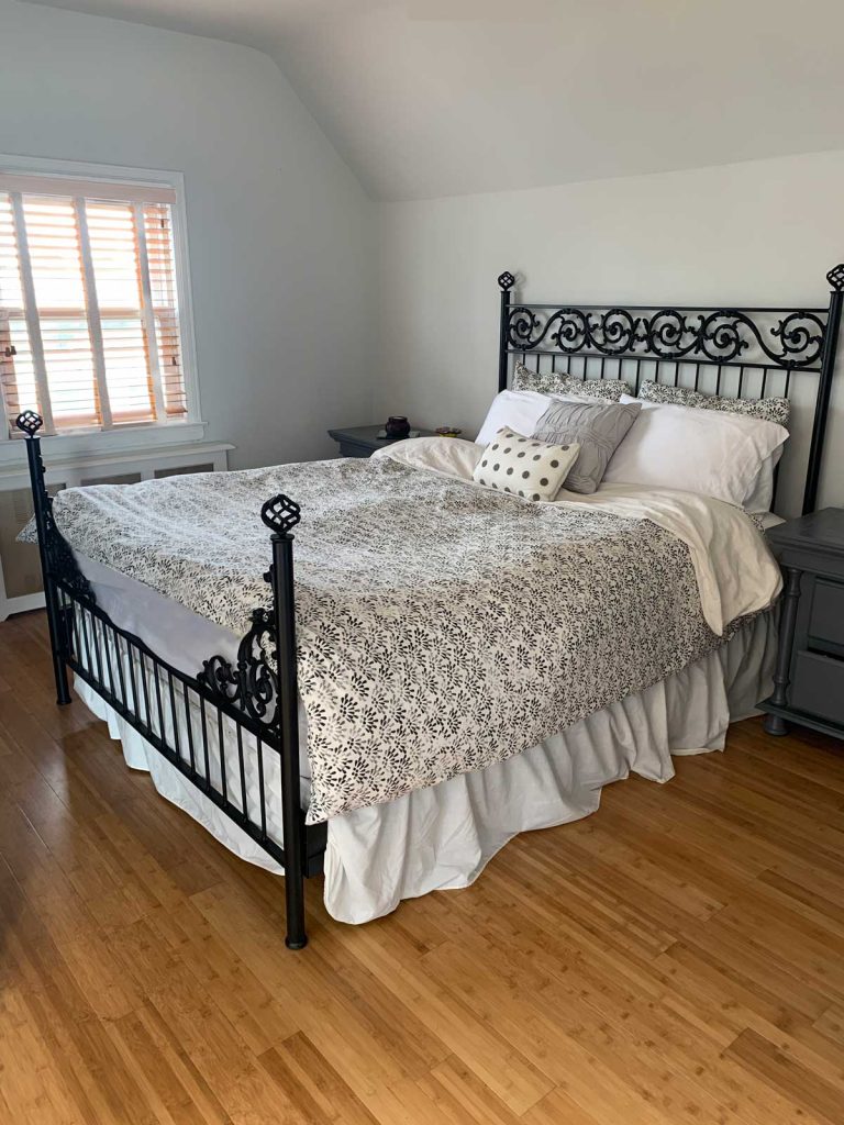 black wrought Iron bed with black and white bedding