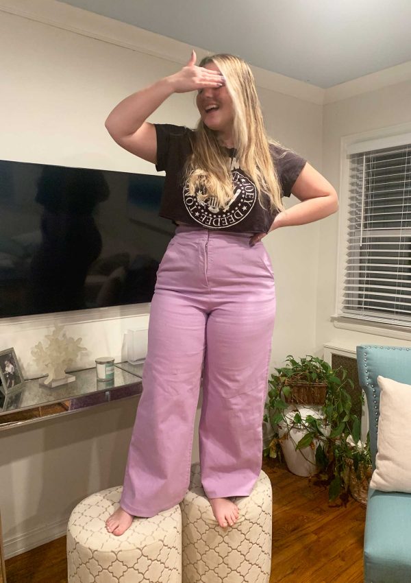 girl standing on stool in hemmed lilac pants