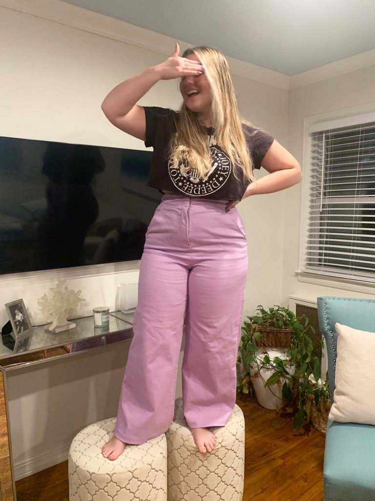 girl standing on stool in hemmed lilac pants