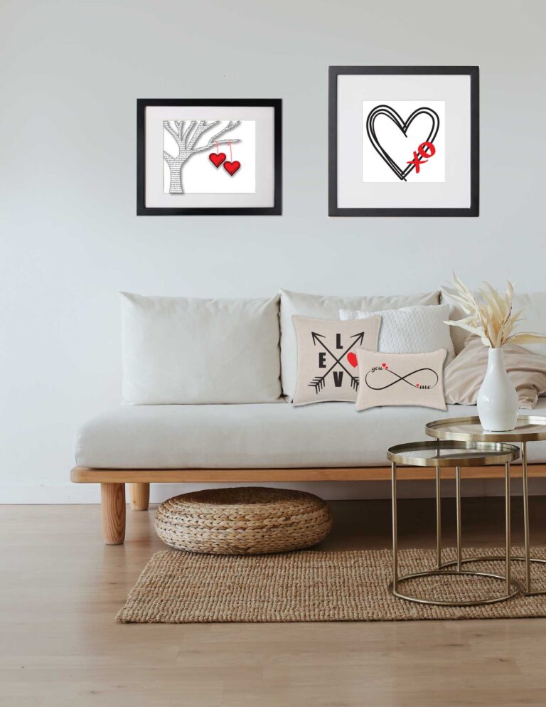Valentines day art in livingroom. two in black frames on walls . two on pillows on couch