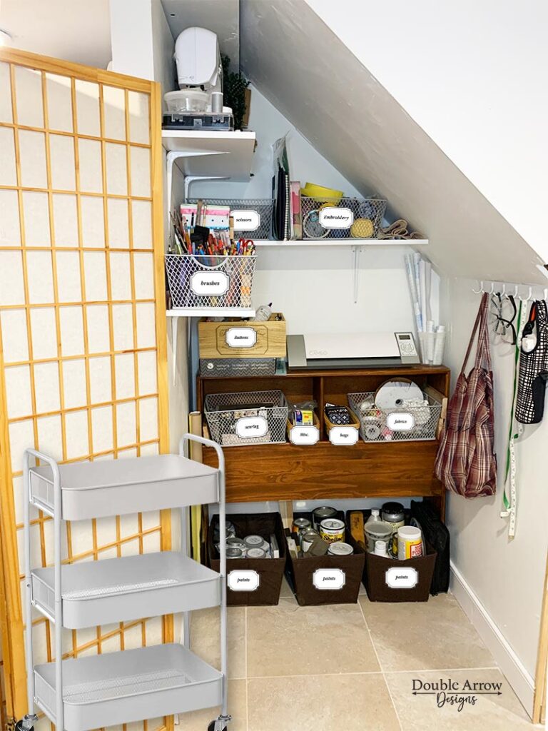craft room storage under staircase with baskets of craft supplies 
