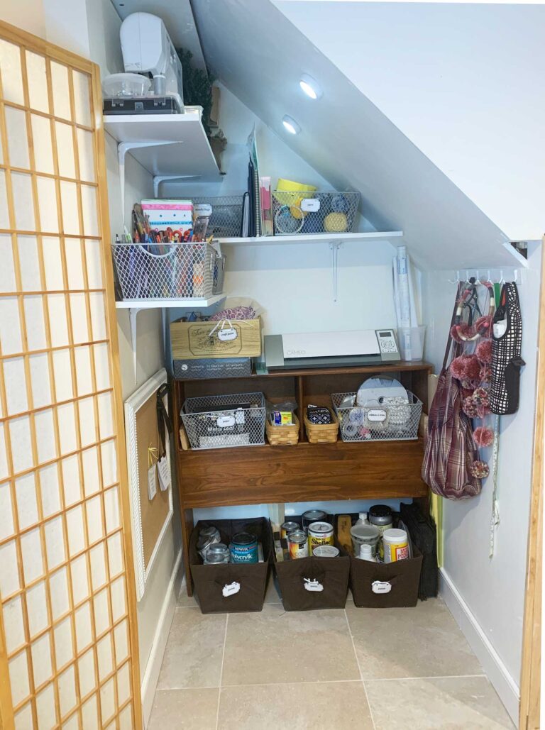 organized craft closet with bins of supplies