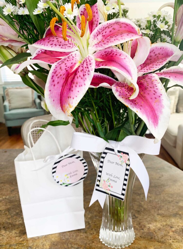 Bouquet of flowers and gift bag with mothers day gift tags attached