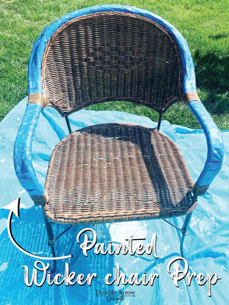 brown wicker chair outside on a lawn with armrests covered in painters tape