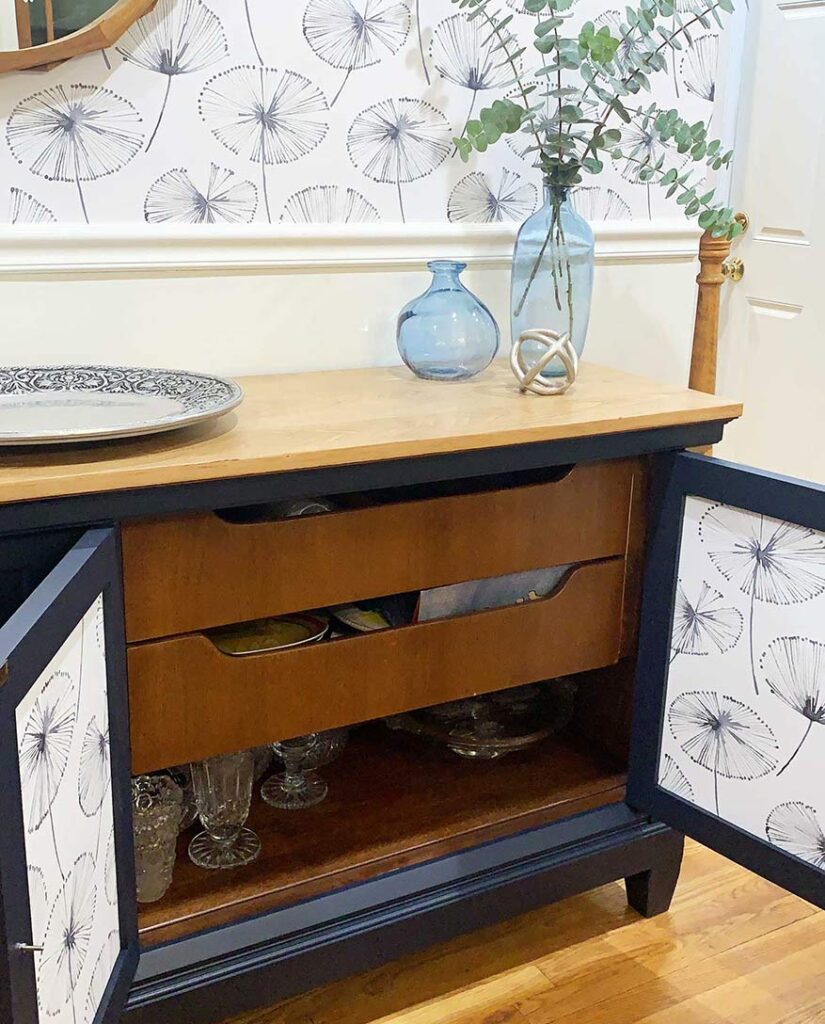 new china cabinet doors open showing peel and stik wallpaper on inside of cabinet doors