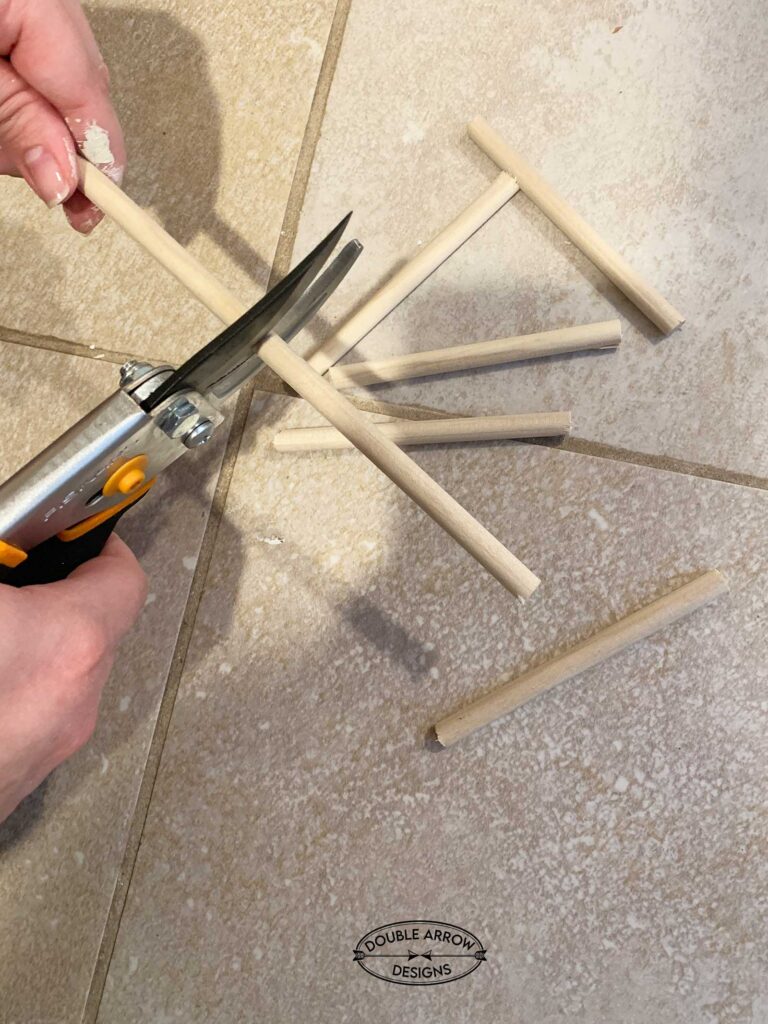 Cutting wood dowels using a pruning shear.