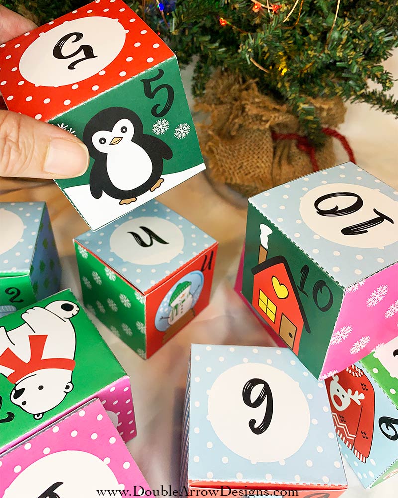 diy advent calendar boxes showing #5 box with a penguin and other assorted advent boxes