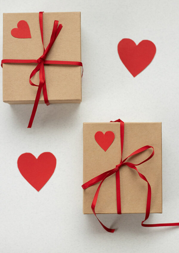 Valentine's day gifts for kids 2 wrapped brown paper boxes w red ribbon and hearts
