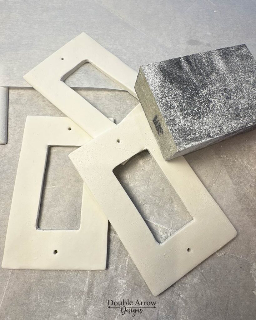 3 polymer clay light covers being sanded