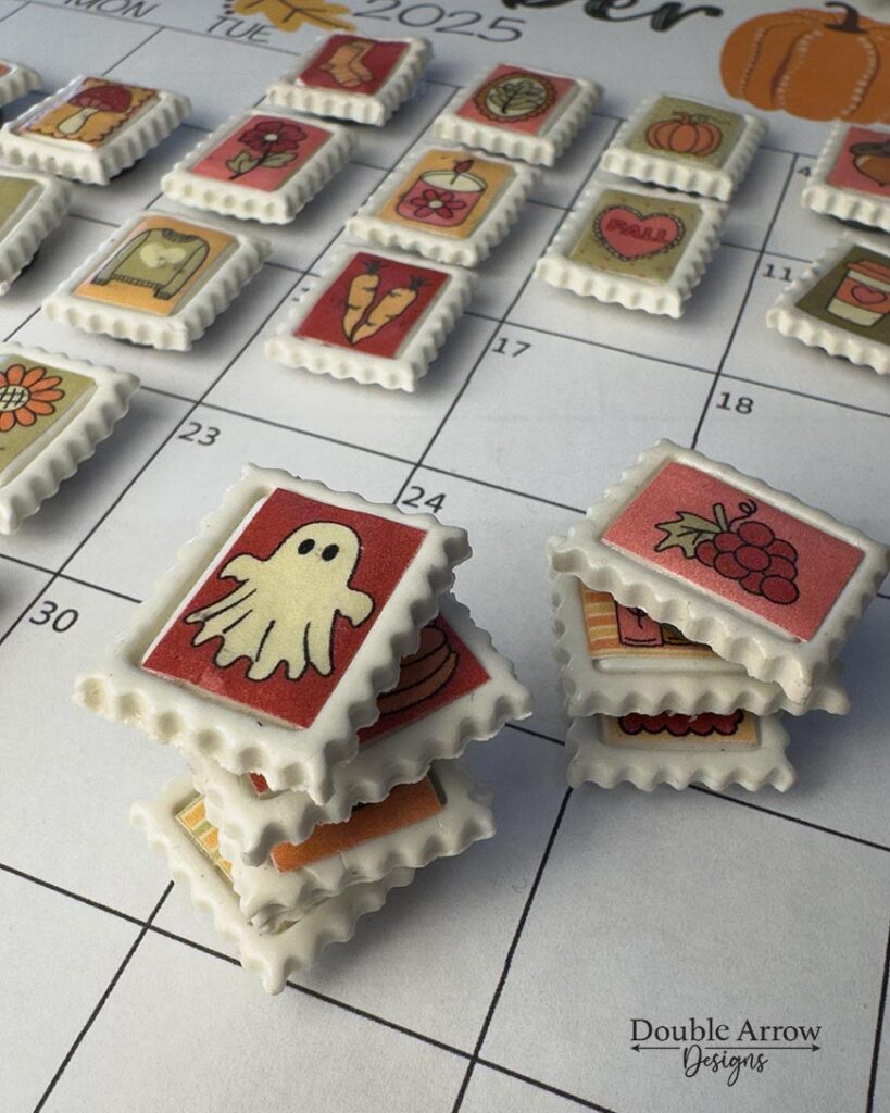 Polymer clay stamps with printed fall icon graphics on a calendar