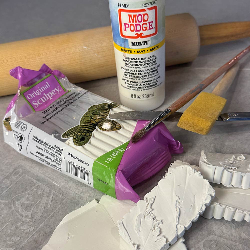 materials to make polymer clay playing card coasters, polymer clay, roling pin, brushes, stencil, mod podge