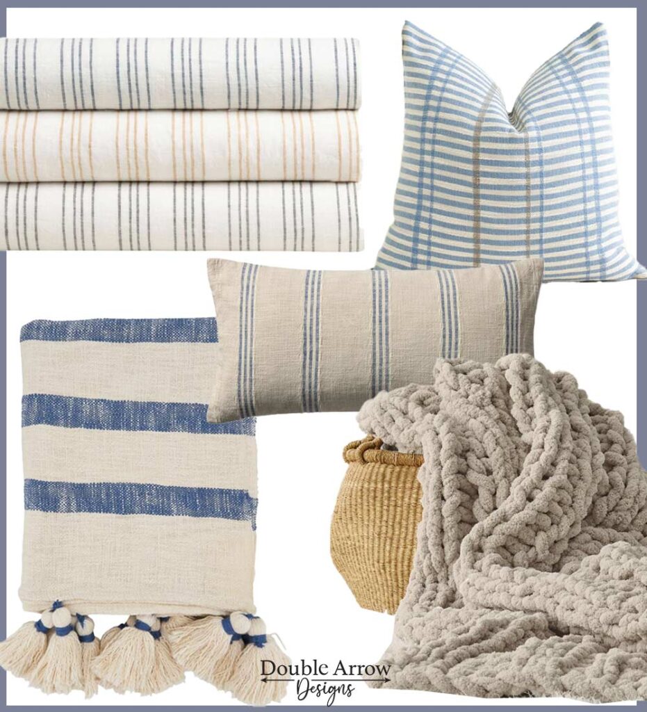 coastal textiles, striped linen bed covers, striped cream, blue, beige pillows, blue and cream throw blanket with tassels, chunky cream chenille blanket sticking out of a rattan basket